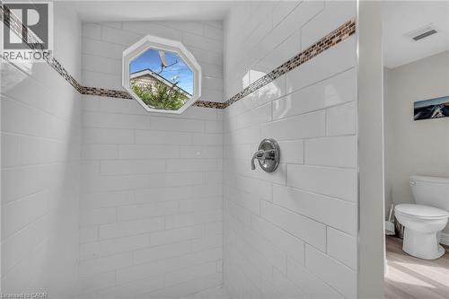 Shower with white subway tile, a decorative mosaic tile accent band, and a chrome shower fixture - 270 Erie Boulevard, Long Point, ON - Indoor Photo Showing Bathroom