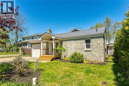 Brick exterior residence featuring a gray metal roof - 270 Erie Boulevard, Long Point, ON - Outdoor