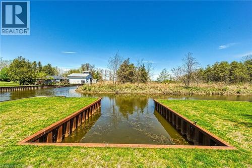Waterfront property featuring a private boat slip with metal retaining walls - 270 Erie Boulevard, Long Point, ON - Outdoor With Body Of Water
