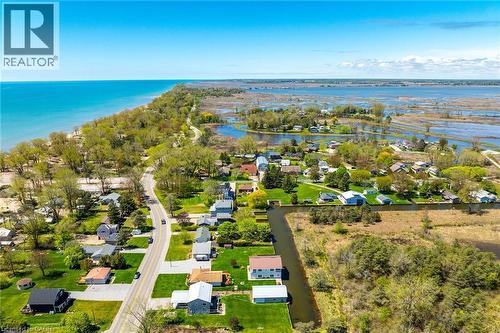 Aerial perspective showcasing a residential community situated between a large body of water and expansive wetlands - 270 Erie Boulevard, Long Point, ON - Outdoor With Body Of Water With View