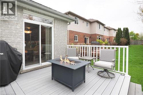 Sliding glass door access, and a manicured lawn. - 565 Springwater Drive, Waterloo, ON - Outdoor With Deck Patio Veranda With Exterior