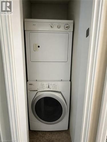 Dedicated laundry closet featuring a stacked washer and dryer unit - 917 Orpha Street, Burlington, ON - Indoor Photo Showing Laundry Room