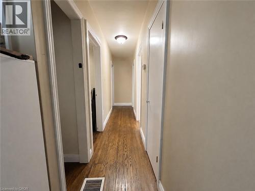 Hallway featuring wood-finish flooring, light-toned wall paint, white trim, and recessed lighting - 917 Orpha Street, Burlington, ON - Indoor Photo Showing Other Room