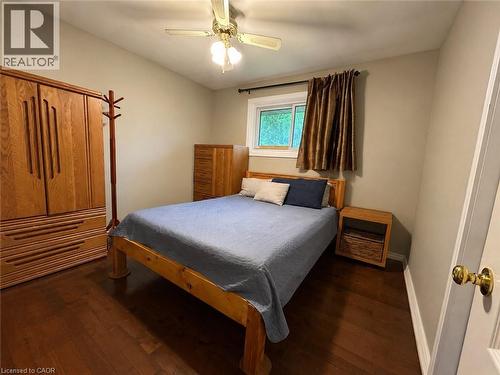 Warm wood-finish flooring complements neutral wall tones - 917 Orpha Street, Burlington, ON - Indoor Photo Showing Bedroom