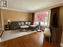 Spacious living area featuring rich wood-finish flooring, a large picture window, crown molding, and neutral wall tones - 917 Orpha Street, Burlington, ON  - Indoor Photo Showing Living Room 