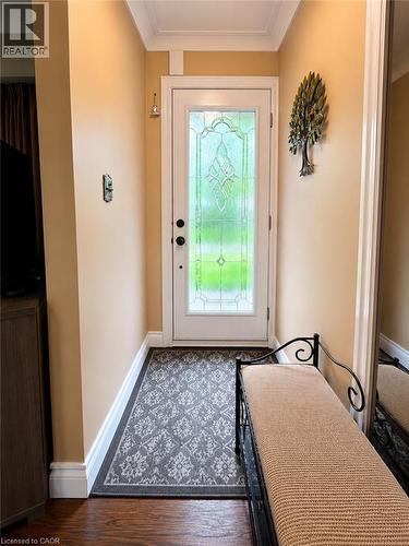 Entryway featuring a white door with decorative glass, hardwood flooring, and crown molding - 917 Orpha Street, Burlington, ON - Indoor Photo Showing Other Room