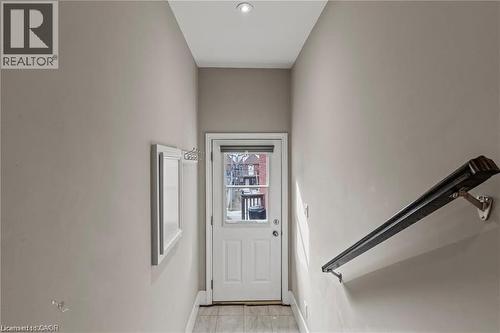 Rear exterior door with frosted glass window and blind, featuring a recessed ceiling light - 181 West Avenue N Unit# 4, Hamilton, ON - Indoor Photo Showing Other Room