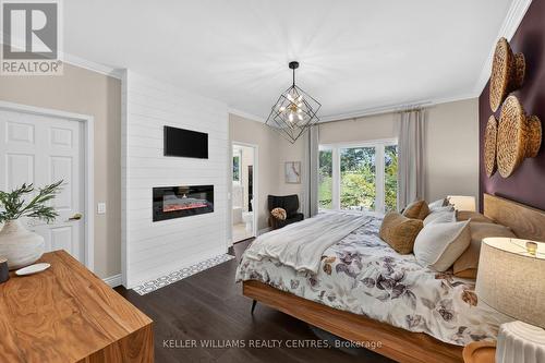 50 Glenhuron Drive, Springwater, ON - Indoor Photo Showing Bedroom With Fireplace
