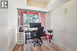 Expansive window with red privacy screens, wood-finish flooring, recessed lighting, and built-in cabinetry with silver hardware - 
