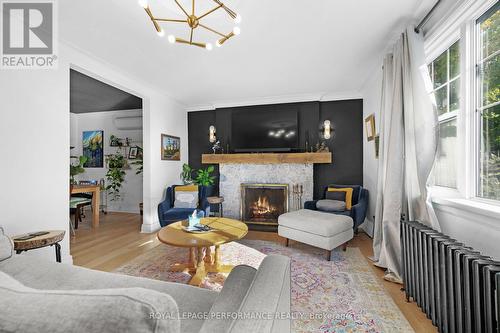 Photo prior to tenant occupancy *digitally staged* - 81 Ivy Crescent, Ottawa, ON - Indoor Photo Showing Living Room With Fireplace