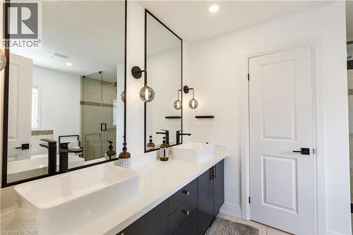 Bathroom featuring a dual vanity with rectangular vessel sinks, matte black faucets, and black framed mirrors - 916 Steepleridge Court, Kitchener, ON - Indoor Photo Showing Bathroom