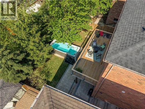 Expansive outdoor living area featuring a cedar deck with railing, a ground-level patio, and a swim spa - 12 Buman Court, Barrie, ON - Outdoor