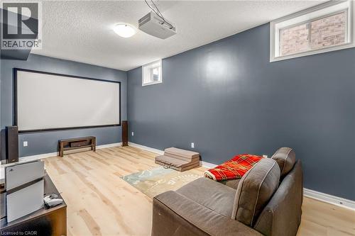 Entertainment room featuring a large projection screen, a ceiling-mounted projector, and light wood-finish flooring - 12 Buman Court, Barrie, ON - Indoor Photo Showing Other Room