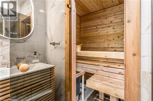 Custom-built sauna featuring cedar paneling and tiered seating - 12 Buman Court, Barrie, ON - Indoor Photo Showing Bathroom