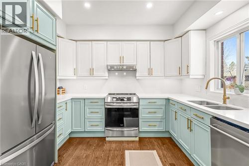 Contemporary kitchen featuring QUARTZ COUNTER TOPS & BACKSPLASH, stainless steel appliances, and wood-finish flooring - 12 Buman Court, Barrie, ON - Indoor Photo Showing Kitchen With Double Sink With Upgraded Kitchen