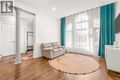 Hardwood-finish flooring extending through the main area, complemented by three arched window units - 12 Buman Court, Barrie, ON - Indoor
