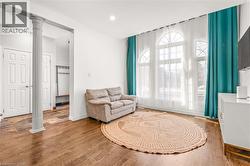Hardwood-finish flooring extending through the main area, complemented by three arched window units - 