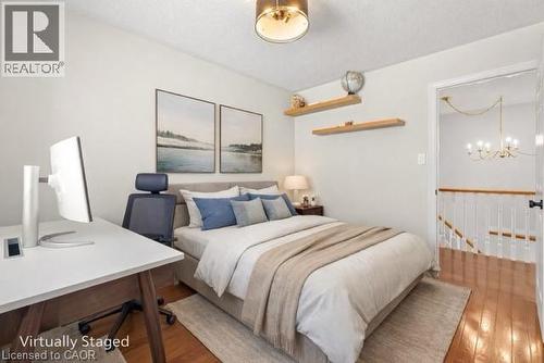 Bright room featuring hardwood flooring, a recessed ceiling light fixture, and two built-in floating shelves - 12 Buman Court, Barrie, ON - Indoor Photo Showing Bedroom