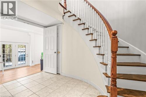 Gracious curved staircase featuring a wood handrail and white balusters - 12 Buman Court, Barrie, ON - Indoor Photo Showing Other Room