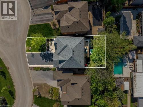 Gable roofline property featuring a paved driveway, front lawn, and a rear deck - 12 Buman Court, Barrie, ON - Outdoor