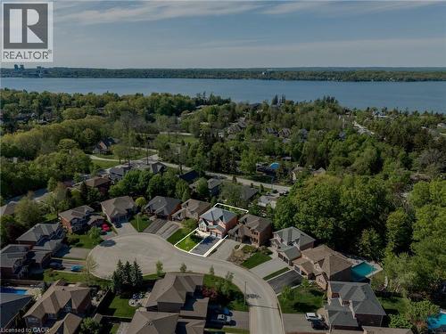 Aerial perspective highlighting a cul-de-sac property with a dark-toned driveway and green lawn - 12 Buman Court, Barrie, ON - Outdoor With Body Of Water With View