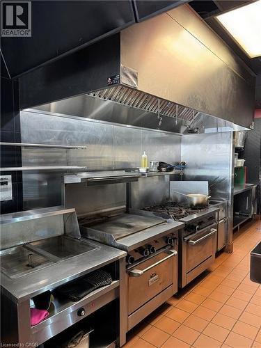 Commercial kitchen featuring stainless steel appliances - 255 King Street N, Waterloo, ON 