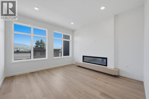 7599 Klinger Road Unit# 18, Okanagan Landing, BC - Indoor Photo Showing Other Room With Fireplace