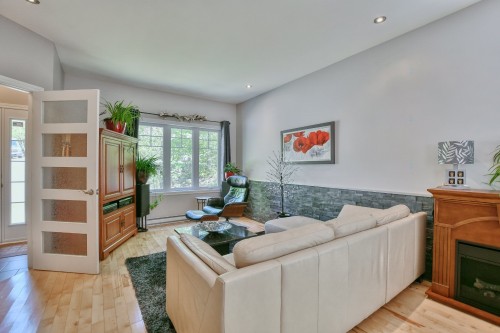 Salon - 14 Rue Boréale, Saint-Hippolyte, QC - Indoor Photo Showing Living Room With Fireplace