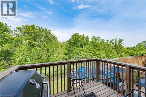 Elevated wood deck with baluster railing, providing an expansive outdoor living area - 9 Fleming Crescent, Caledonia, ON - Outdoor With Deck Patio Veranda
