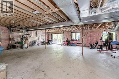 Spacious unfinished basement offering exposed wood joists, concrete flooring, and multiple windows - 9 Fleming Crescent, Caledonia, ON - Indoor