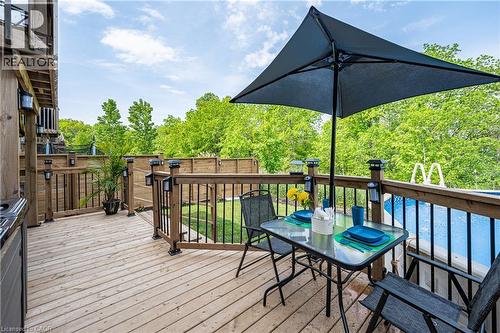 Wood-plank deck featuring a dark wood railing with black balusters and integrated solar post cap lights - 9 Fleming Crescent, Caledonia, ON - Outdoor With Deck Patio Veranda With Exterior