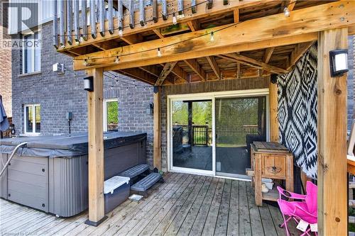 Outdoor wood deck featuring a covered hot tub, a second-story wooden deck overhead, and a sliding glass door entry - 9 Fleming Crescent, Caledonia, ON - Outdoor With Deck Patio Veranda With Exterior