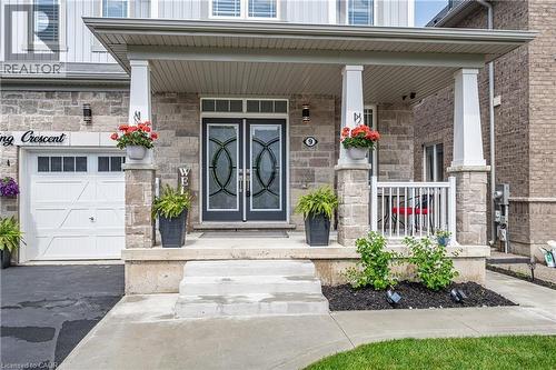 Stone facade with prominent covered porch and double entry doors - 9 Fleming Crescent, Caledonia, ON - Outdoor With Facade