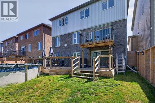 Rear exterior featuring a multi-level wood deck, a second-story balcony with wood railings, and a ground-level patio - 9 Fleming Crescent, Caledonia, ON - Outdoor With Deck Patio Veranda