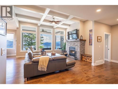 Living room on main floor with panoramic views of Okanagan Lake - 132 Crown Crescent, Vernon, BC - Indoor Photo Showing Living Room With Fireplace