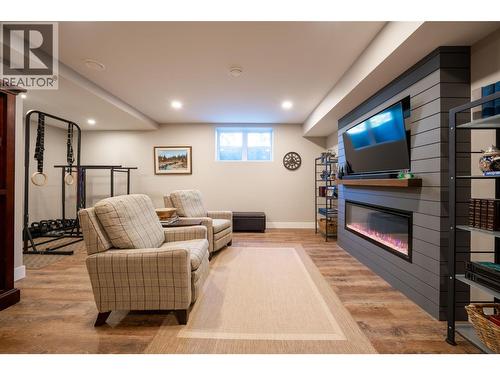 Basement family room - 132 Crown Crescent, Vernon, BC - Indoor Photo Showing Basement With Fireplace