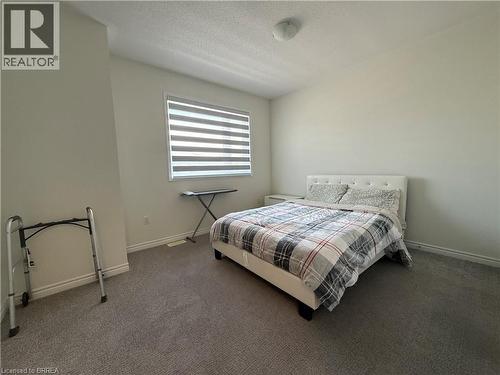 Carpeted interior space featuring a window with horizontal blinds, neutral wall paint, and a flush-mount ceiling light fixture - 18 Dolucci Crescent, Brampton, ON - Indoor Photo Showing Bedroom
