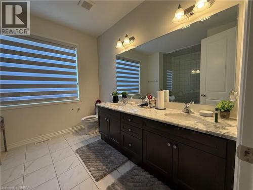 Double vanity featuring dark wood-finish cabinetry and a light-toned countertop - 18 Dolucci Crescent, Brampton, ON - Indoor Photo Showing Bathroom