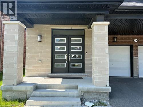 Contemporary facade featuring a stone veneer exterior and double entry doors with frosted glass panels - 18 Dolucci Crescent, Brampton, ON - Outdoor