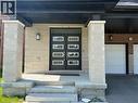 Contemporary facade featuring a stone veneer exterior and double entry doors with frosted glass panels - 18 Dolucci Crescent, Brampton, ON  - Outdoor 