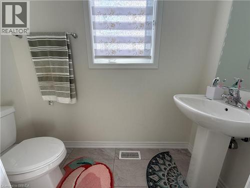 Bathroom featuring a pedestal sink, white toilet, and window with privacy blinds - 18 Dolucci Crescent, Brampton, ON - Indoor Photo Showing Bathroom