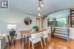 Hardwood flooring throughout featuring a multi-level design with a prominent staircase - 