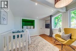 Bright room featuring wood-finish flooring, recessed lighting, and a large window - 