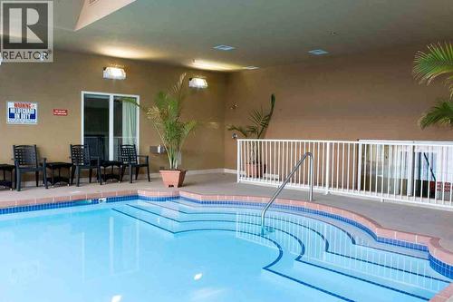 1088 Sunset Drive Unit# 635, Kelowna, BC - Indoor Photo Showing Other Room With In Ground Pool