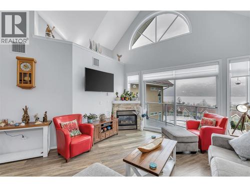 This photo has the owners furnishings but they have now been removed. - 1088 Sunset Drive Unit# 635, Kelowna, BC - Indoor Photo Showing Living Room With Fireplace
