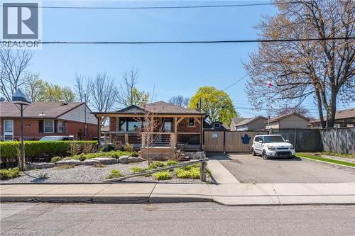 Brick facade residence with a covered front porch featuring wood-look posts and a stone base - 151 Winchester Boulevard, Hamilton, ON - Outdoor With Facade
