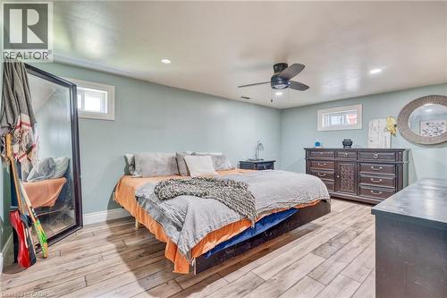 Spacious bedroom featuring wood-finish flooring, light blue wall paint, recessed lighting, and a ceiling fan - 151 Winchester Boulevard, Hamilton, ON - Indoor Photo Showing Bedroom