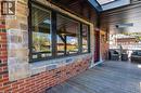 Stone and brick exterior with black-framed windows and a red entry door - 151 Winchester Boulevard, Hamilton, ON  - Outdoor With Deck Patio Veranda 