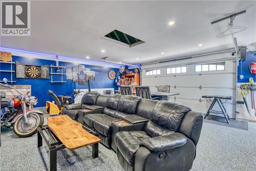 Finished garage space featuring a roll-up garage door with integrated windows, recessed lighting, and a skylight - 151 Winchester Boulevard, Hamilton, ON - Indoor Photo Showing Garage