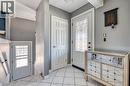Entryway featuring white square floor tiles, a decorative front door with leaded glass, and an additional white paneled interior door - 151 Winchester Boulevard, Hamilton, ON  - Indoor Photo Showing Other Room 